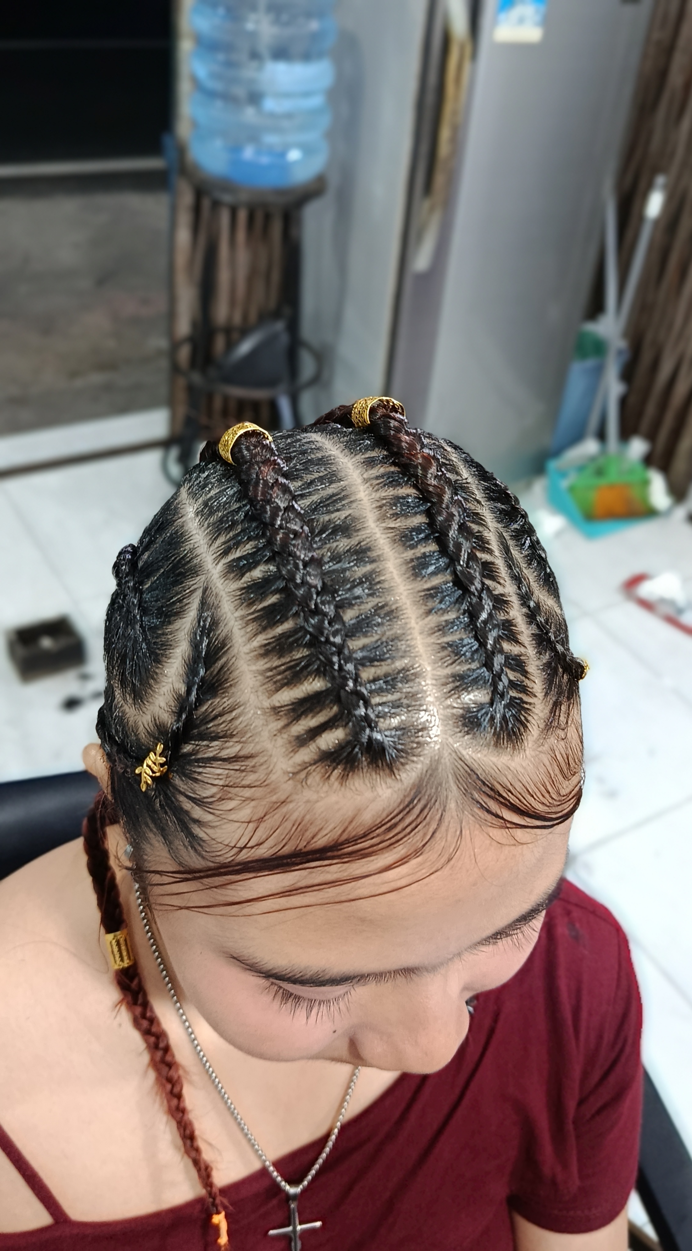 Custom cornrows braids with gold rings — premium braiding service